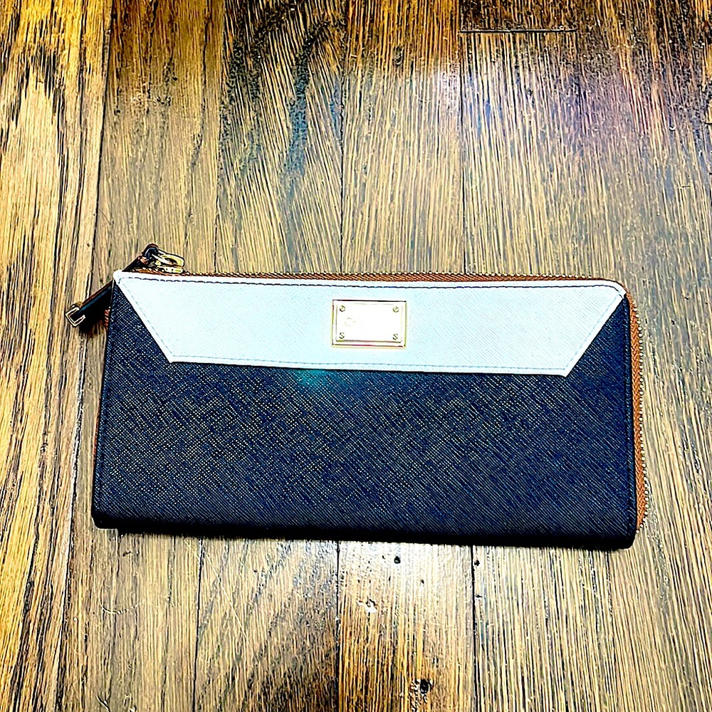 Calvin Klein 8 x 4 wallet NWOT. Black with white trim and gold color zipper.